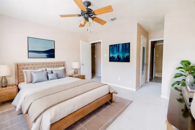 a bedroom with bed and a ceiling fan