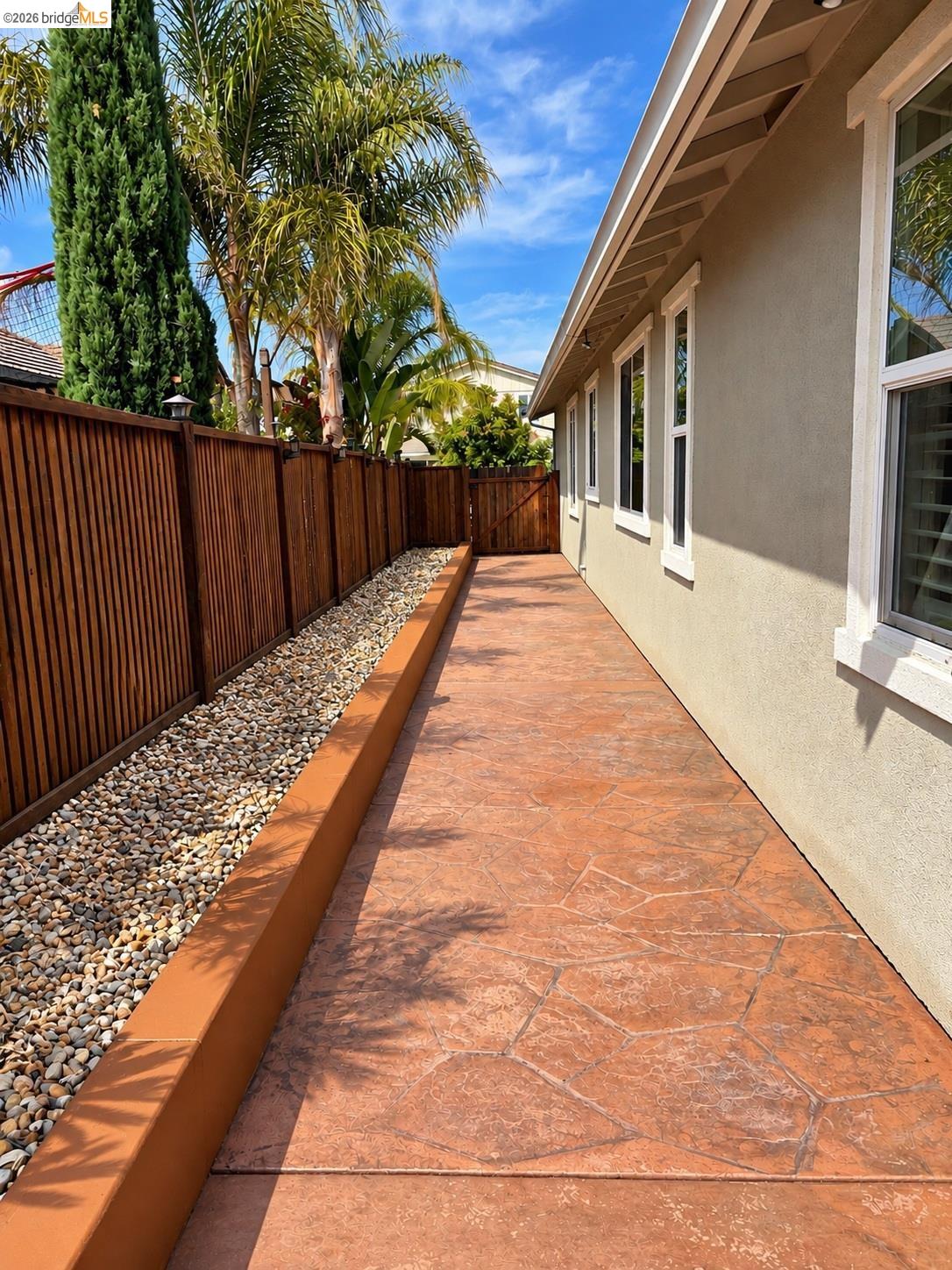 809 Ibis Road Oakley, CA 94561 - Photo 20 of 32 Stamped concrete pathway alongside a stucco exterior