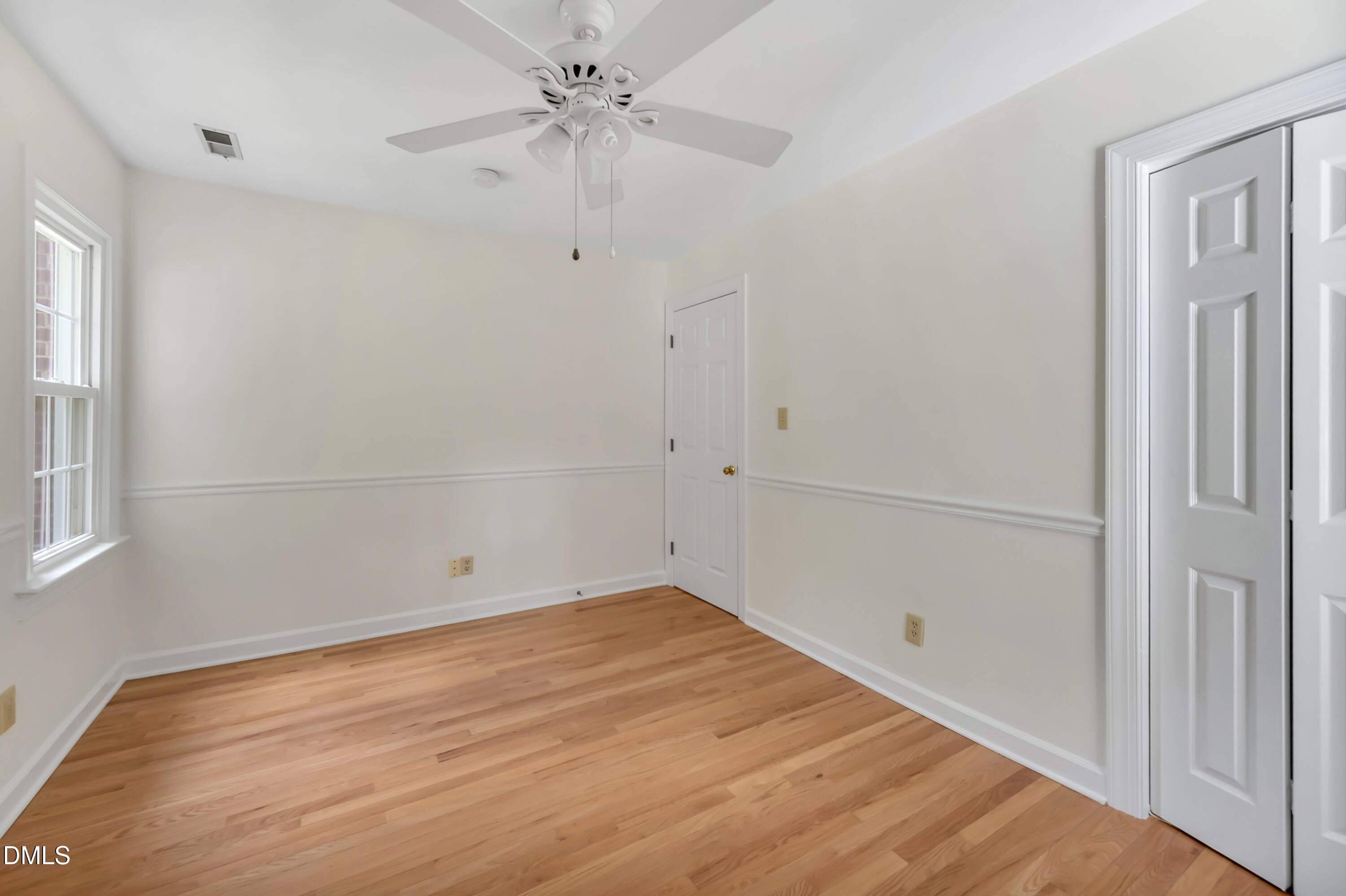 7500 Drayton Court Raleigh, NC 27615 - Photo 17 of 27 wooden floor in an empty room with a window