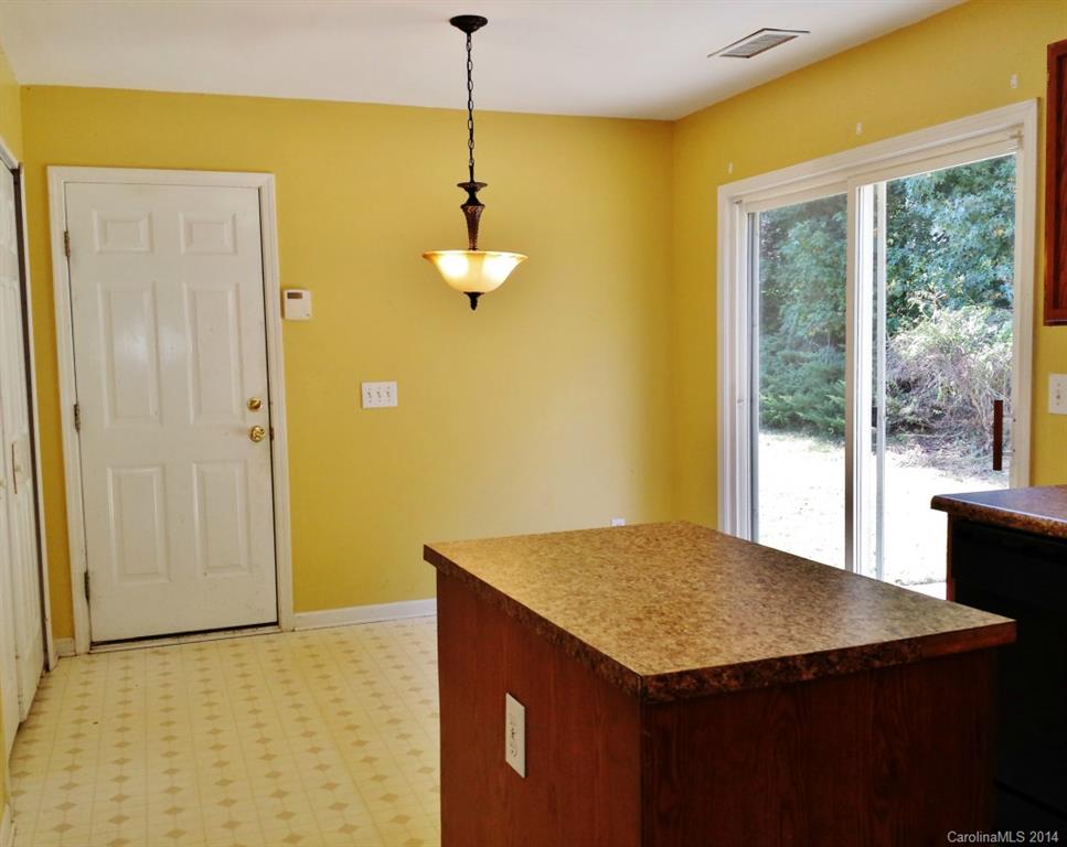 11414 Gold Pan Road Charlotte, NC 28215 - Photo 11 of 24 a kitchen that has a microwave and a table in it