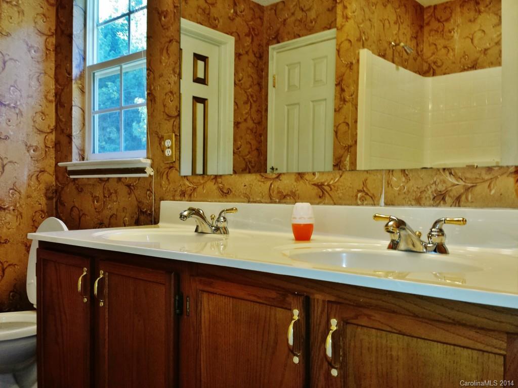 11414 Gold Pan Road Charlotte, NC 28215 - Photo 17 of 24 a bathroom with a sink and a mirror