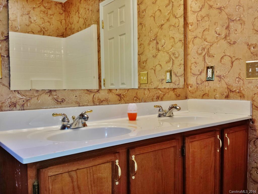 11414 Gold Pan Road Charlotte, NC 28215 - Photo 18 of 24 a bathroom with a sink and a mirror