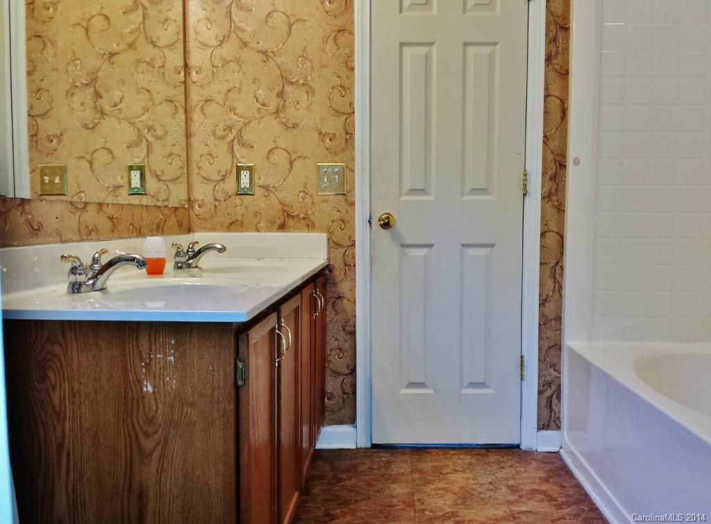 11414 Gold Pan Road Charlotte, NC 28215 - Photo 19 of 24 a bathroom with a sink and a mirror