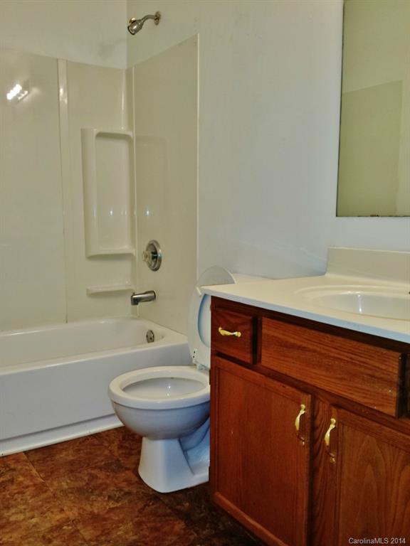 11414 Gold Pan Road Charlotte, NC 28215 - Photo 22 of 24 a bathroom with a sink a toilet and shower
