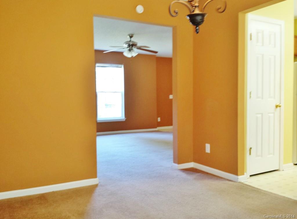 11414 Gold Pan Road Charlotte, NC 28215 - Photo 7 of 24 an empty room with windows and fan