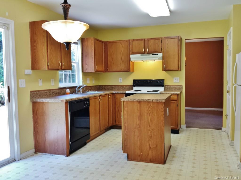 11414 Gold Pan Road Charlotte, NC 28215 - Photo 8 of 24 a kitchen with stainless steel appliances granite countertop a stove a sink and a refrigerator