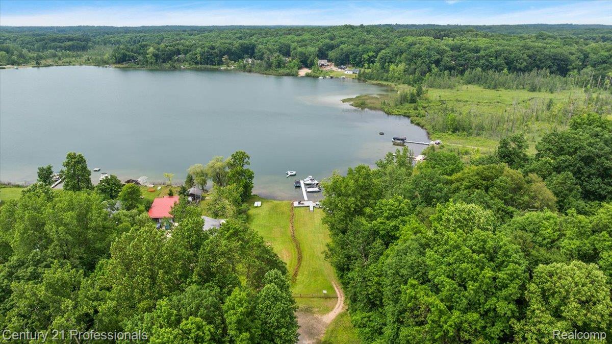 9867 Rainbow Ridge Drive Schoolcraft, MI 49087 - Photo 73 of 82 Expansive lakefront property featuring a private boat dock, lush green landscaping, and mature surrounding woodlands