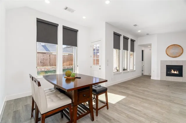 a kitchen with a dining table chairs sink and cabinets