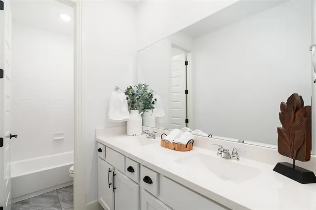 a view of workspace with wooden floor and white cabinet