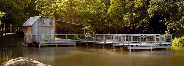 a small white house with a large pool