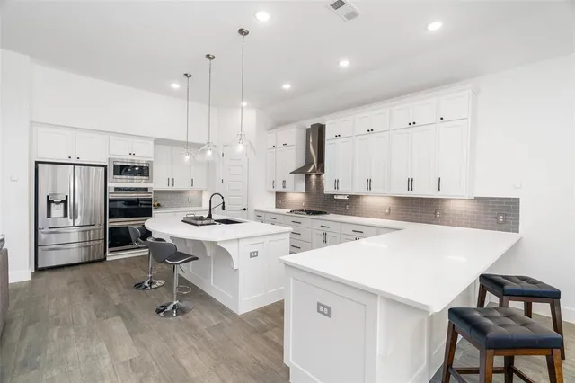 a kitchen with a sink a stove a refrigerator and island