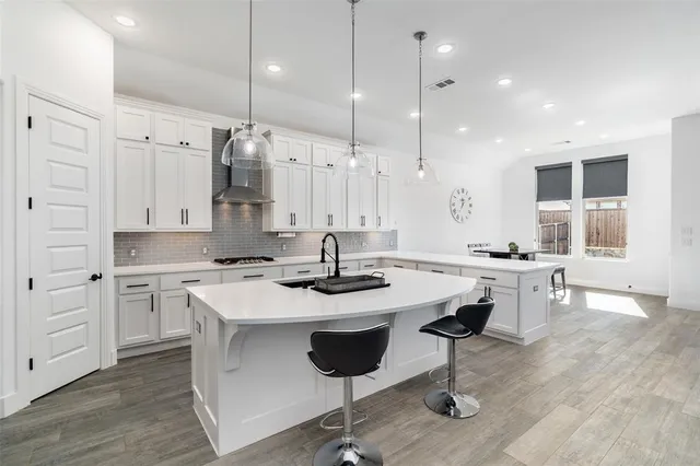 a kitchen with a sink stove and microwave