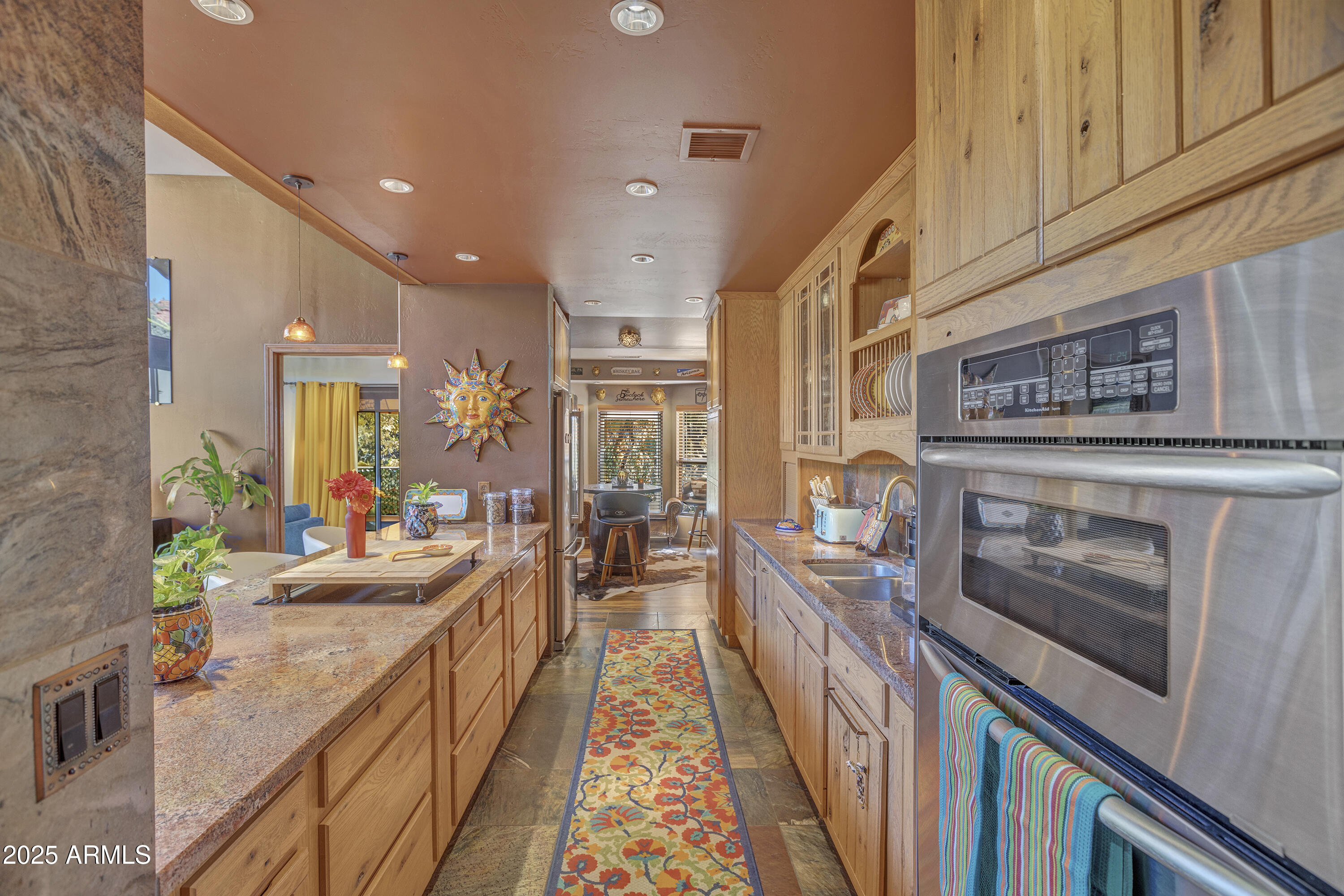 30 Box Canyon Road Sedona, AZ 86351 - Photo 13 of 30 a view of a kitchen with kitchen island stainless steel appliances a stove a sink and a refrigerator