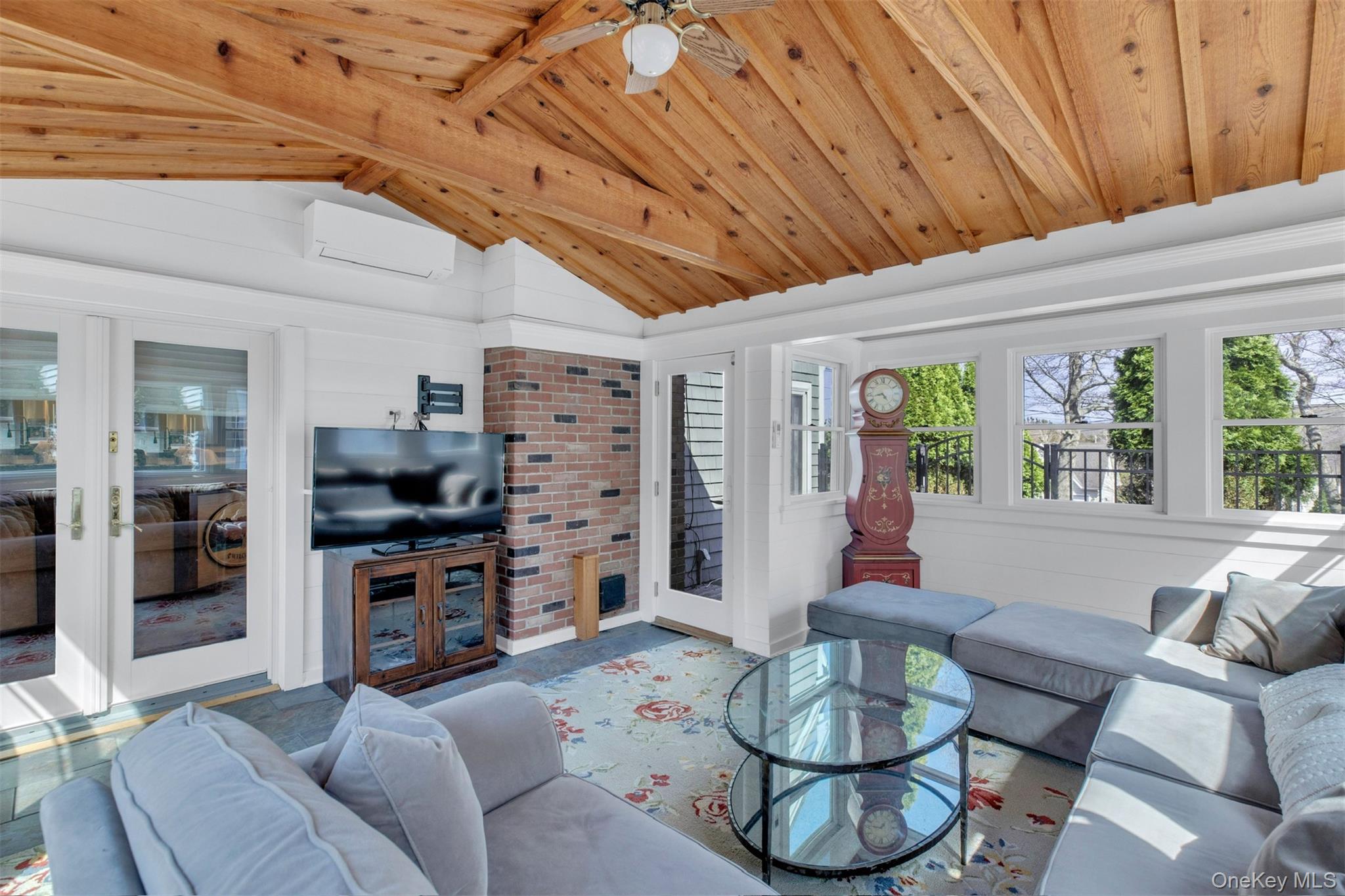 345 Colonial Road Southold, NY 11971 - Photo 16 of 43 a living room with furniture and a flat screen tv