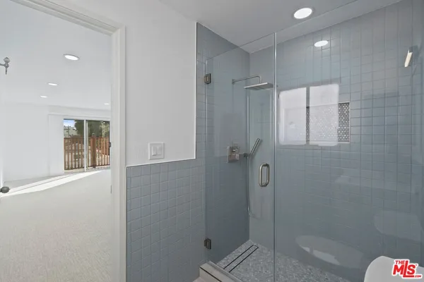 a bathroom with a toilet sink shower and mirror