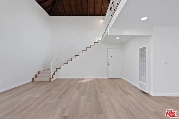 a view of entryway with stairs and wooden floor