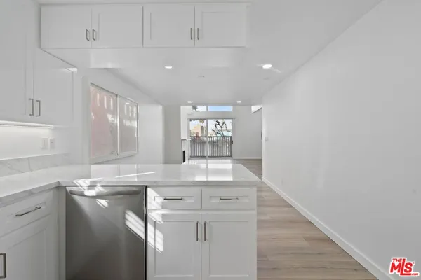 a kitchen with kitchen island a sink stainless steel appliances and cabinets
