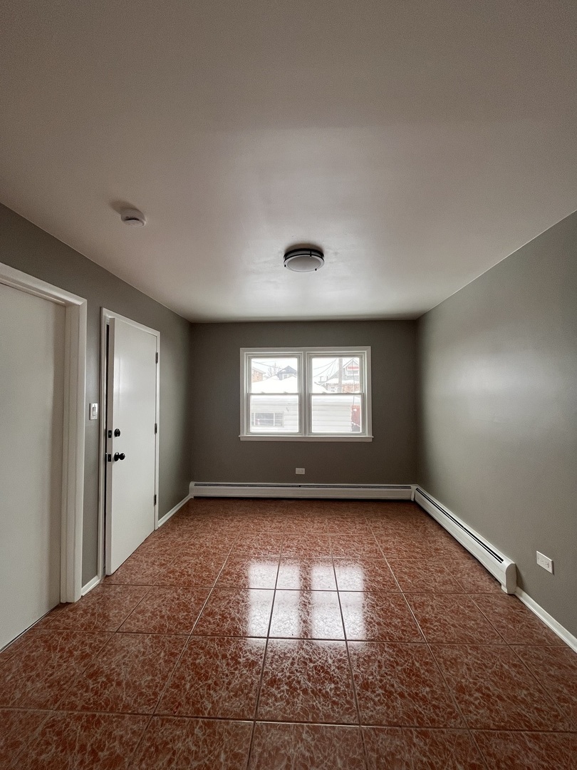 6138 South Kilpatrick Avenue, Unit 1 Chicago, IL 60629 - Photo 11 of 11 a view of empty room with a window