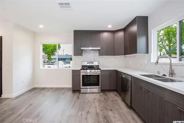 a kitchen with a sink and a stove