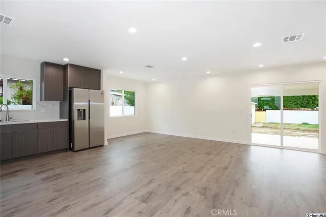 a view of a refrigerator in kitchen and wooden floor