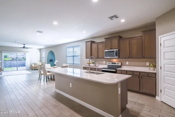 a kitchen with a sink stove and cabinets