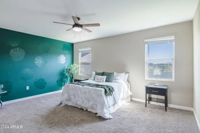 a bedroom with a bed and a chandelier