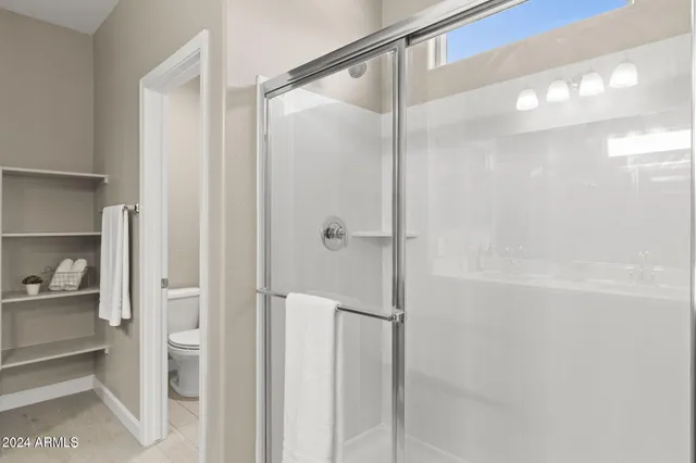 a bathroom with a glass shower door