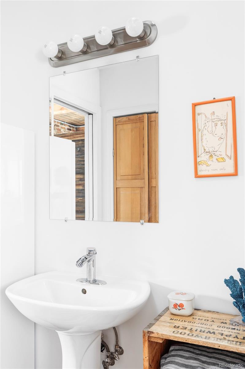 3733 Franklin Street Denver, CO 80205 - Photo 13 of 29 a bathroom with a sink and a mirror