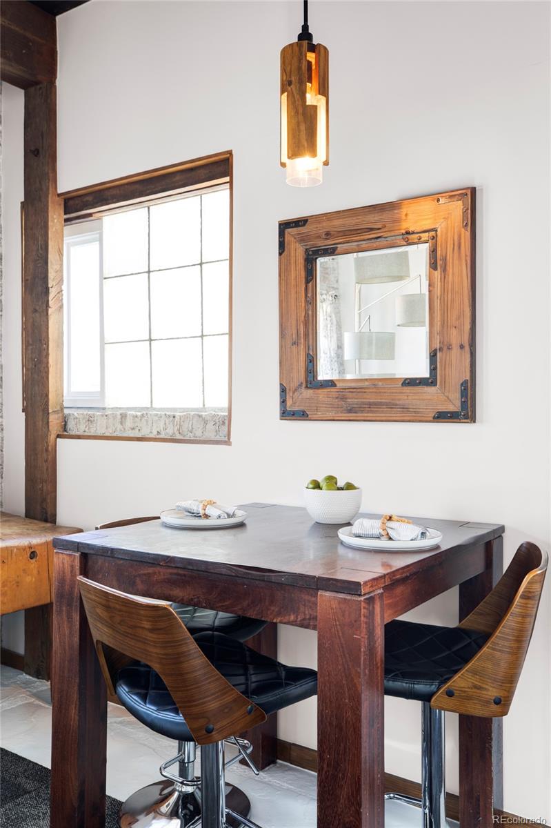 3733 Franklin Street Denver, CO 80205 - Photo 20 of 29 a view of a dining room with furniture and window