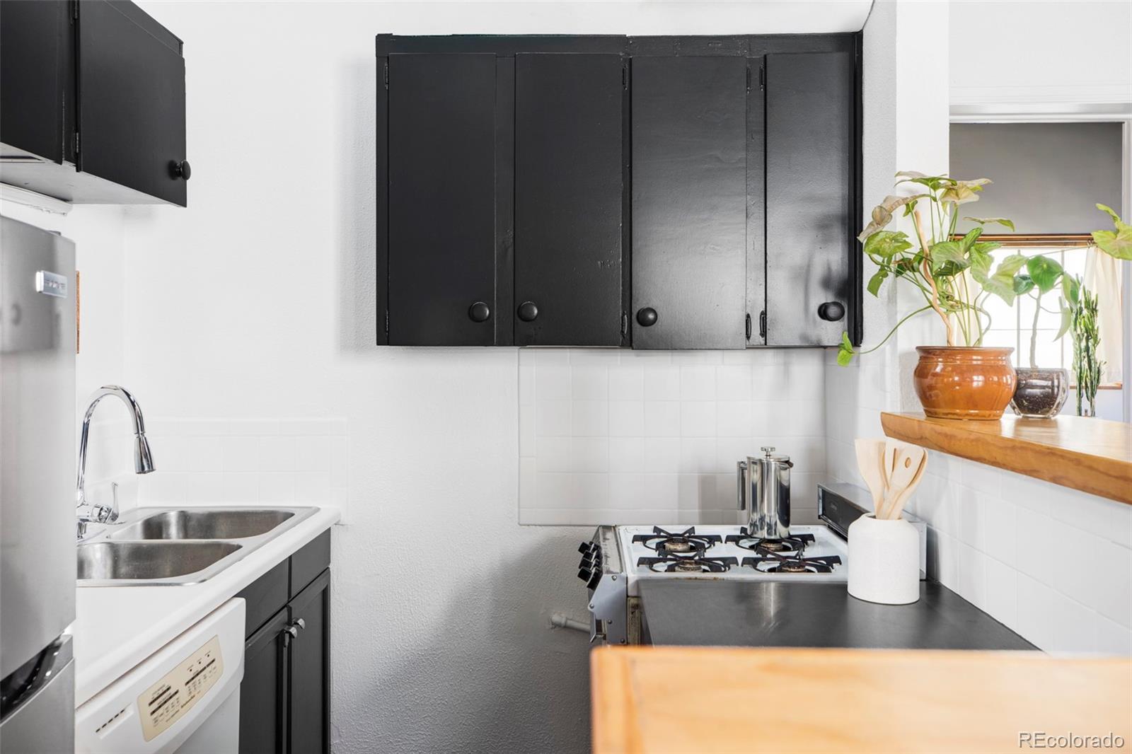 3733 Franklin Street Denver, CO 80205 - Photo 22 of 29 a kitchen with a sink and cabinets