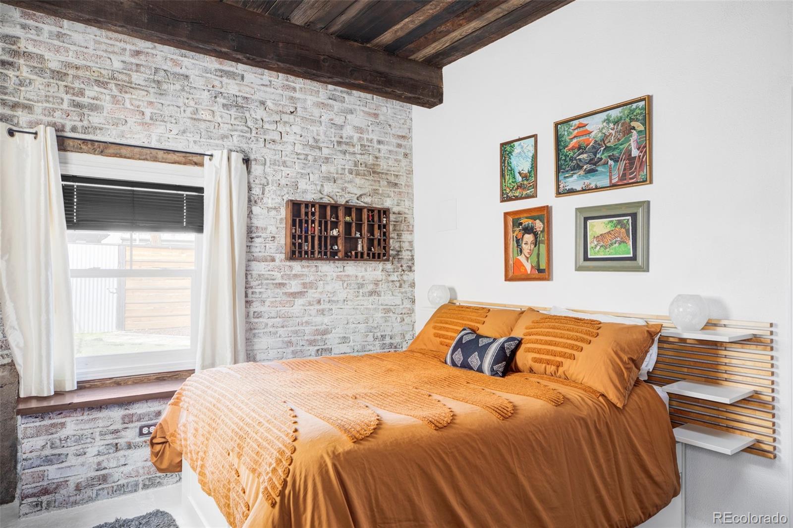 3733 Franklin Street Denver, CO 80205 - Photo 23 of 29 a bedroom with a bed and a painting on the wall