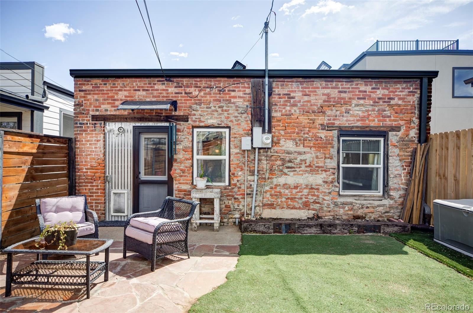 3733 Franklin Street Denver, CO 80205 - Photo 27 of 29 a view of a patio with a table and chairs and potted plants