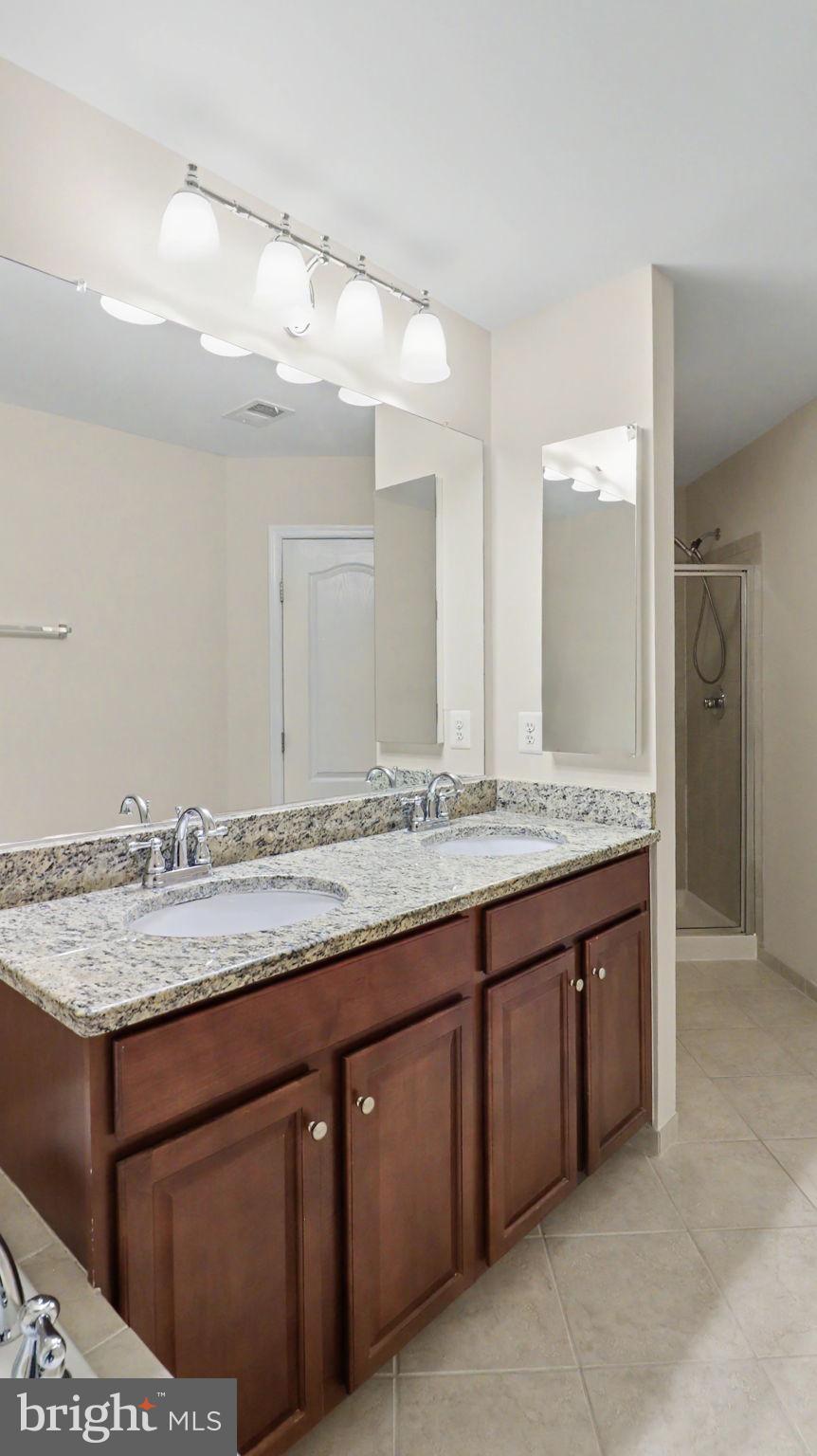 42371 Trellis Square Brambleton, VA 20148 - Photo 40 of 70 Elegant dual-sink bathroom retreat.