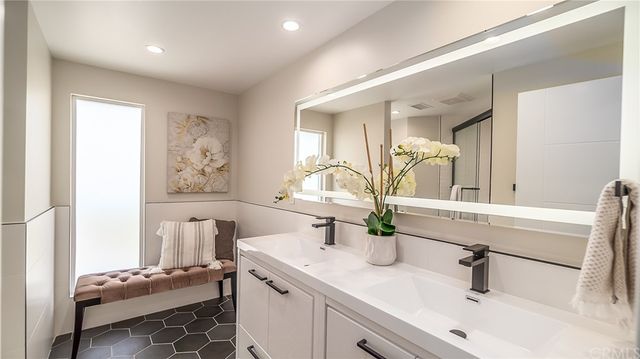 a bathroom with a sink a toilet and mirror