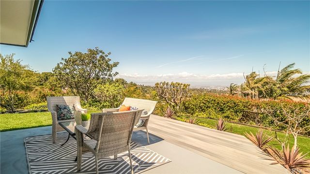 a view of a patio with table and chairs and wooden floor