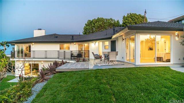 an aerial view of residential houses with outdoor space and trees