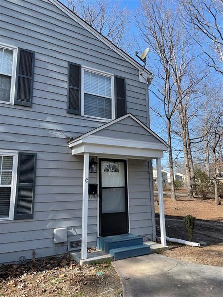 a front view of a house with a tree