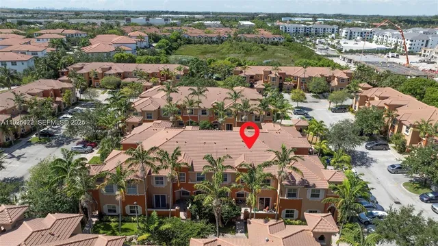 an aerial view of residential houses with outdoor space
