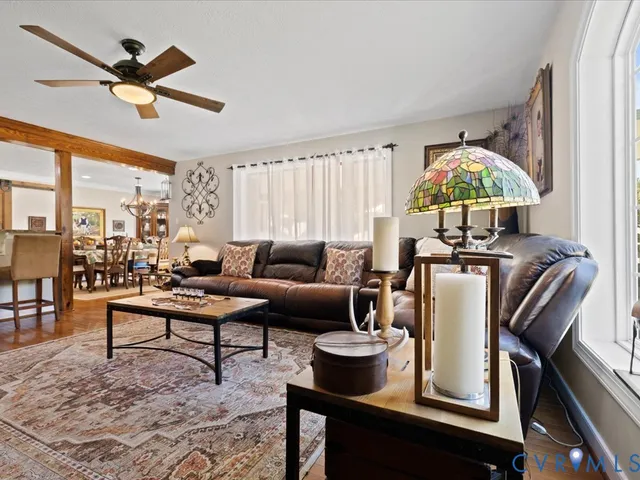 a living room with furniture and a chandelier