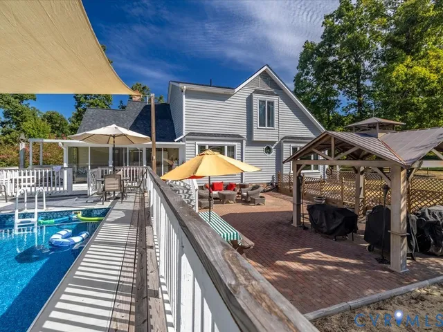 a view of a house with wooden deck and furniture