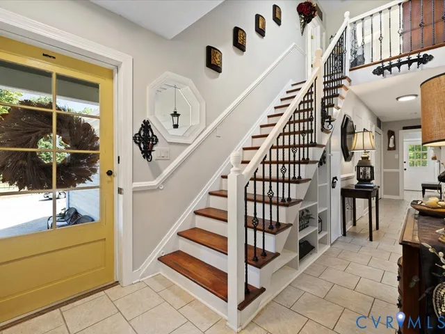 a view of entryway with wooden floor and windows