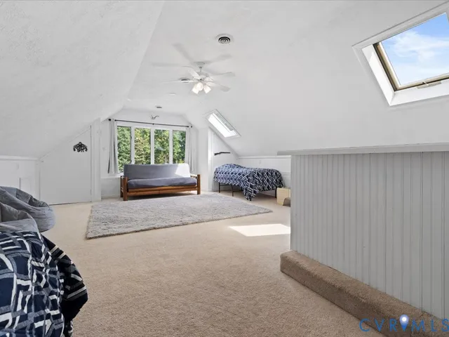 a living room with a bed furniture and a window