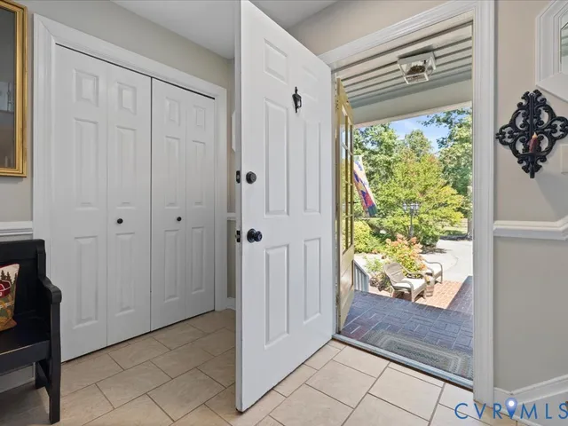 a view of entryway with window and front door