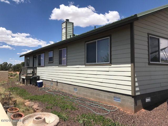 242 County Road Concho, AZ 85924 - Photo 2 of 28 a back view of a house with a yard