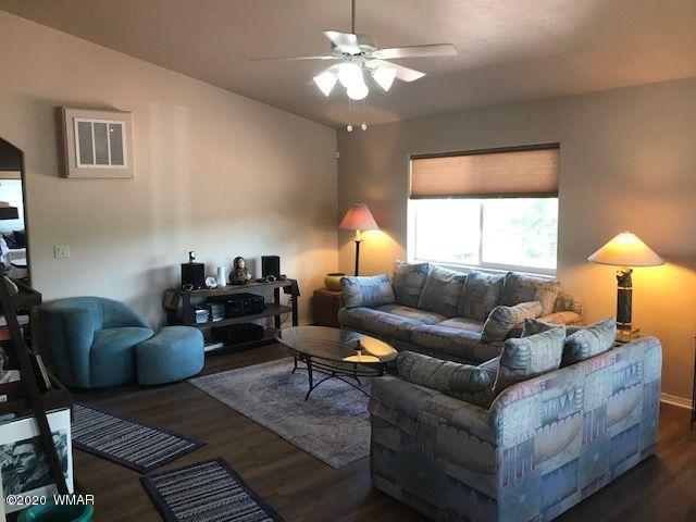 242 County Road Concho, AZ 85924 - Photo 22 of 28 a living room with furniture a lamp and a chandelier