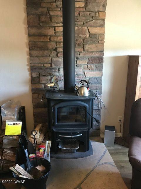 242 County Road Concho, AZ 85924 - Photo 27 of 28 a living room with furniture a flat screen tv and a fireplace