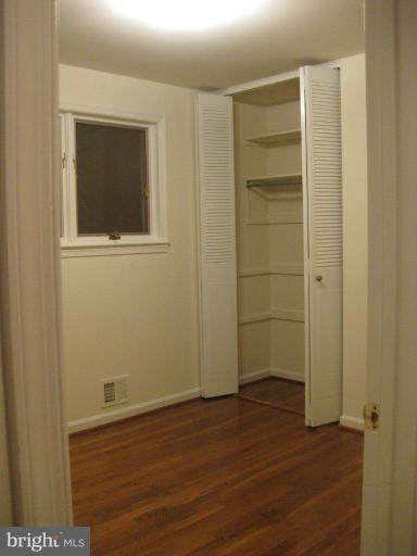 8455 Thames Street Springfield, VA 22151 - Photo 11 of 19 a view of an empty room with wooden floor and closet