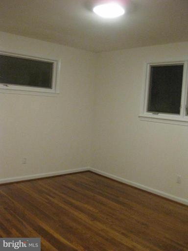 8455 Thames Street Springfield, VA 22151 - Photo 14 of 19 a view of an empty room with wooden floor and a window