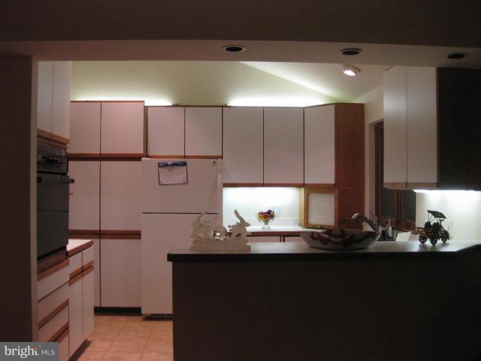 8455 Thames Street Springfield, VA 22151 - Photo 5 of 19 a kitchen with kitchen island appliances a sink and cabinets