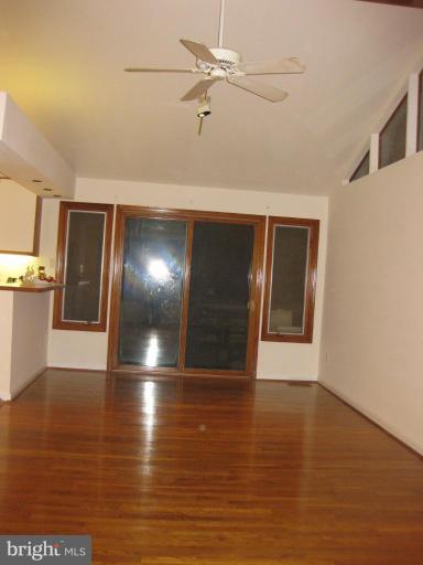 8455 Thames Street Springfield, VA 22151 - Photo 9 of 19 a view of an empty room with window and wooden floor